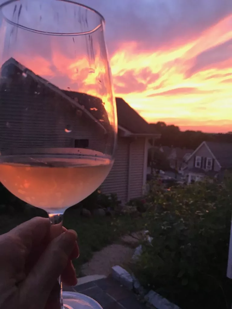 Sunset in Gloucester, MA with Rosé wine of the same color