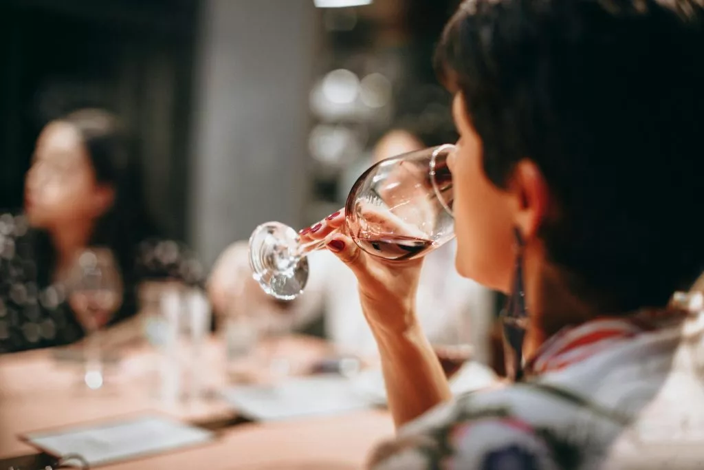 Person Drinking Wine by Helena Lopes via Pexels