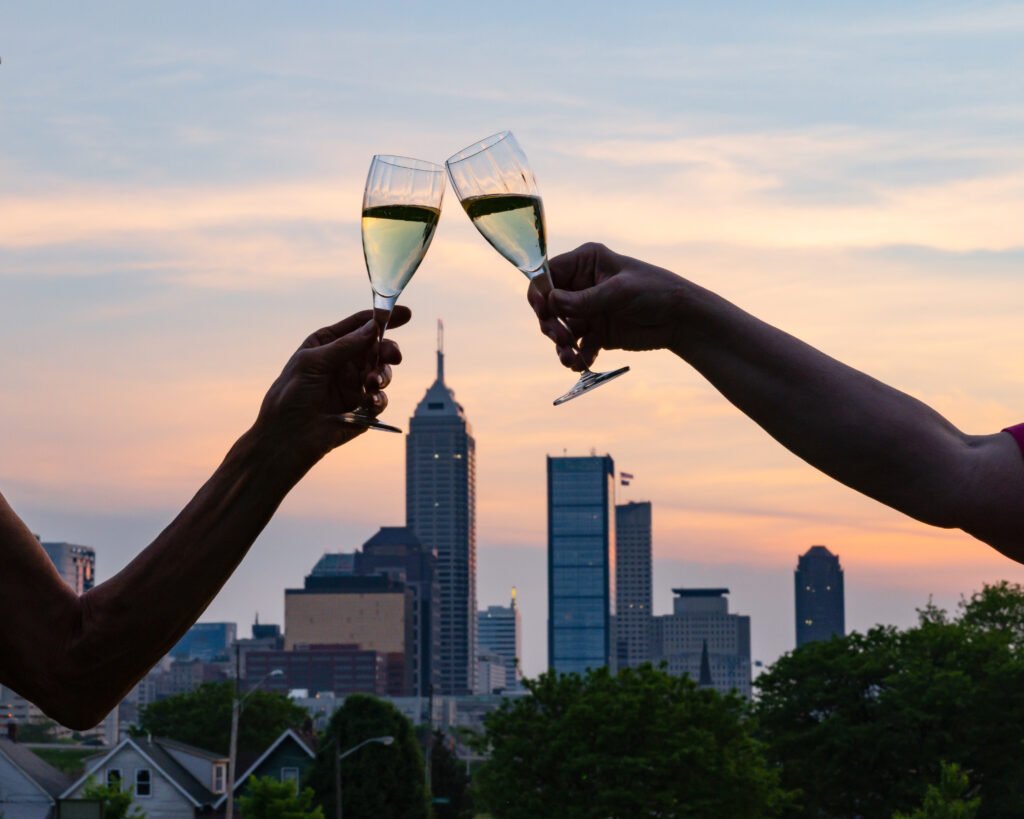 Toast with wine glasses over Indianapolis, Indiana